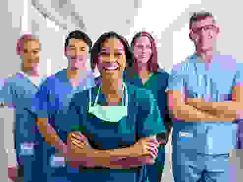 A group of happy doctors in scrubs